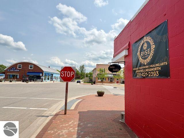 180 S Benzie Blvd, Beulah, MI 49617 - view of asphalt street featuring traffic signs and sidewalks
