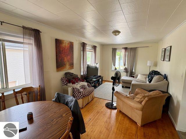 180 S Benzie Blvd, Beulah, MI 49617 - living area with light wood-type flooring and crown molding