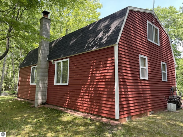 5218 E Laird Lake Rd, Hale, MI 48739 - view of side of home featuring a shingled roof and a chimney