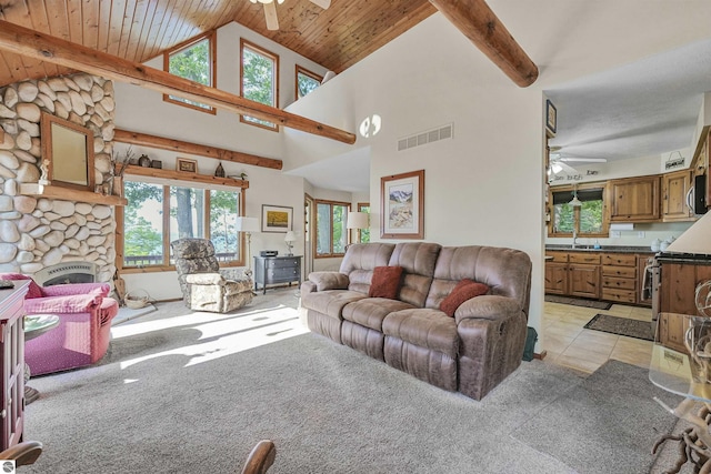 6387 W Maple St, Lake City, MI 49651 - living room featuring a ceiling fan, light carpet, a wooden ceiling with exposed beams, high vaulted ceiling, and a stone fireplace