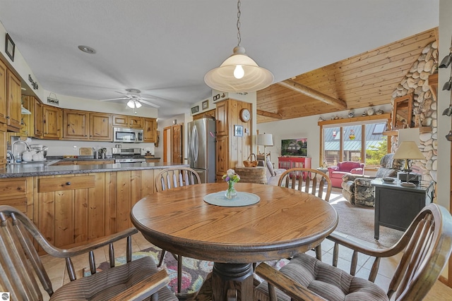 6387 W Maple St, Lake City, MI 49651 - dining space with ceiling fan, light tile patterned flooring, and vaulted ceiling