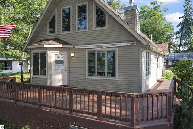 6387 W Maple St, Lake City, MI 49651 - view of front of house with a deck and a chimney