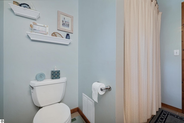 6387 W Maple St, Lake City, MI 49651 - bathroom with toilet and a shower with shower curtain