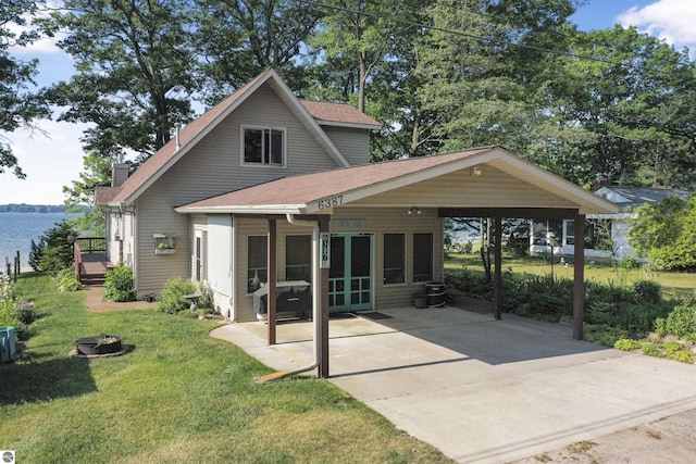6387 W Maple St, Lake City, MI 49651 - rear view of property with a carport, a yard, a deck, a chimney, and roof with shingles