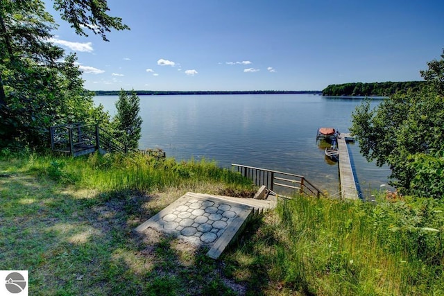 7600 Maple St, Grawn, MI 49637 - water view featuring a boat dock
