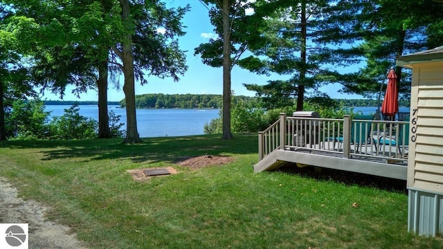 7600 Maple St, Grawn, MI 49637 - view of green lawn featuring a water view