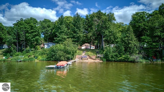 7600 Maple St, Grawn, MI 49637 - dock featuring a water view and a forest view