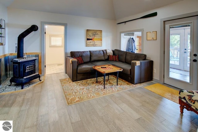 7600 Maple St, Grawn, MI 49637 - living area featuring wood finished floors, a wood stove, and lofted ceiling