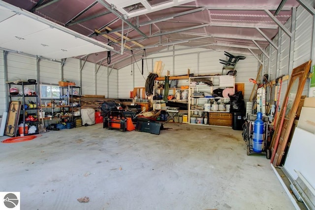 7600 Maple St, Grawn, MI 49637 - garage featuring a workshop area