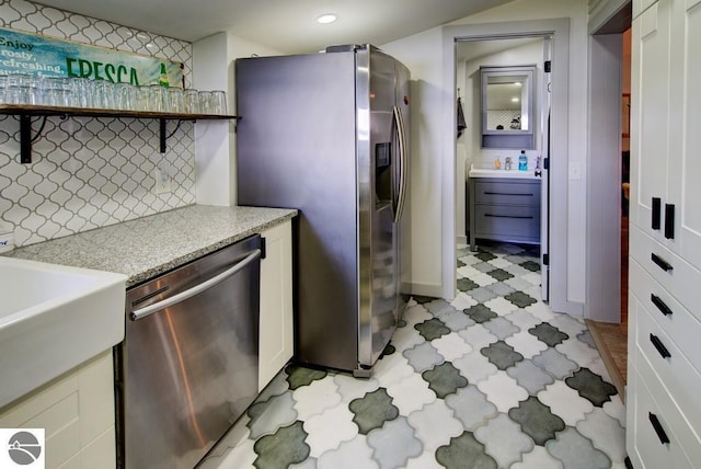 7600 Maple St, Grawn, MI 49637 - kitchen featuring stainless steel appliances, light flooring, open shelves, light stone countertops, and recessed lighting