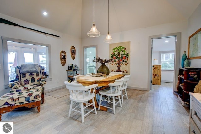 7600 Maple St, Grawn, MI 49637 - dining room featuring light wood finished floors, vaulted ceiling, and recessed lighting