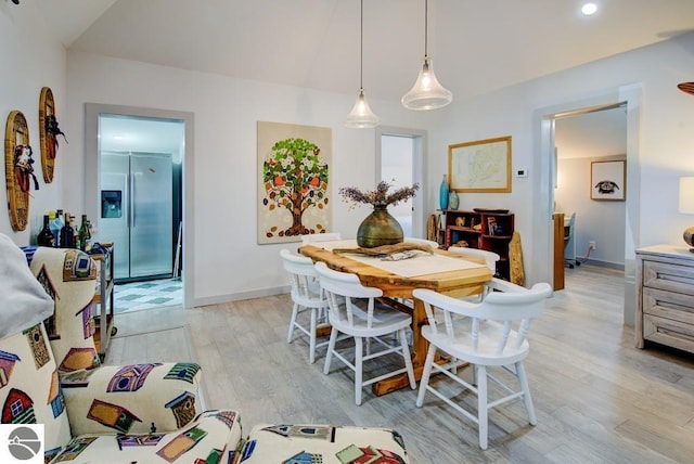 7600 Maple St, Grawn, MI 49637 - dining area featuring light wood-type flooring and lofted ceiling