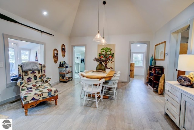 7600 Maple St, Grawn, MI 49637 - dining area featuring light wood-style floors and high vaulted ceiling