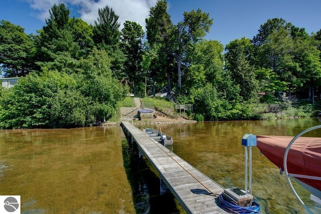 7600 Maple St, Grawn, MI 49637 - dock area with a water view and view of wooded area