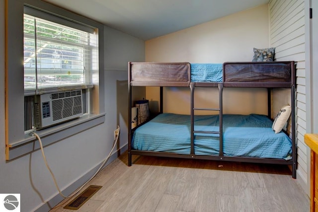 7600 Maple St, Grawn, MI 49637 - bedroom featuring lofted ceiling, wood finished floors, and cooling unit