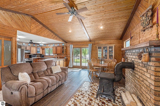 8781 Clam Lake Rd, Bellaire, MI 49615 - living area featuring wooden walls, a ceiling fan, vaulted ceiling, wood-type flooring, and wood ceiling
