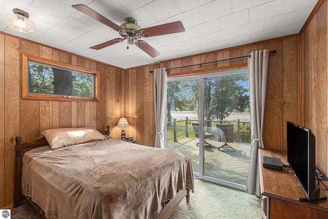 8781 Clam Lake Rd, Bellaire, MI 49615 - bedroom with access to outside, wood walls, light colored carpet, and a ceiling fan