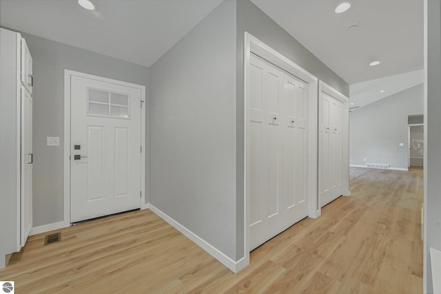 6483 Jeffrey Pl, Grawn, MI 49637 - entrance foyer with light wood finished floors, lofted ceiling, and recessed lighting