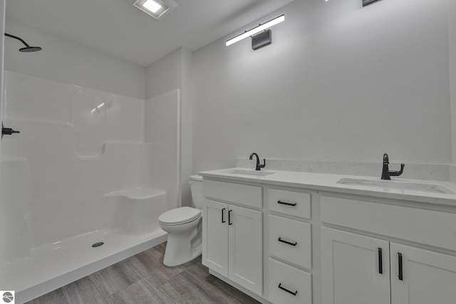 6483 Jeffrey Pl, Grawn, MI 49637 - full bath with double vanity, a shower, and wood finished floors