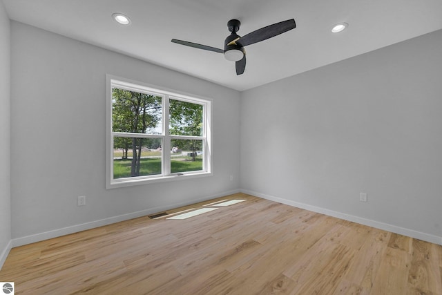 6483 Jeffrey Pl, Grawn, MI 49637 - unfurnished room with light wood-style flooring, a ceiling fan, and recessed lighting