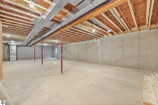 6483 Jeffrey Pl, Grawn, MI 49637 - unfinished basement featuring heating unit