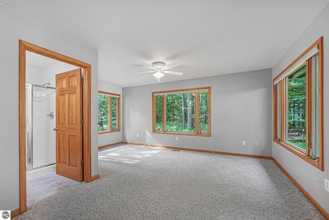 10085 Harmony Dr, Interlochen, MI 49643 - carpeted spare room featuring a ceiling fan and baseboards