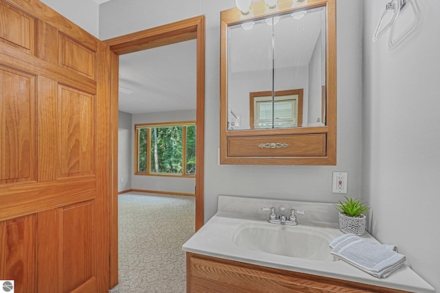 10085 Harmony Dr, Interlochen, MI 49643 - bathroom featuring vanity and baseboards