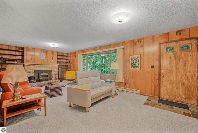 10085 Harmony Dr, Interlochen, MI 49643 - living room featuring a baseboard heating unit, wood walls, a textured ceiling, built in shelves, and a wood stove