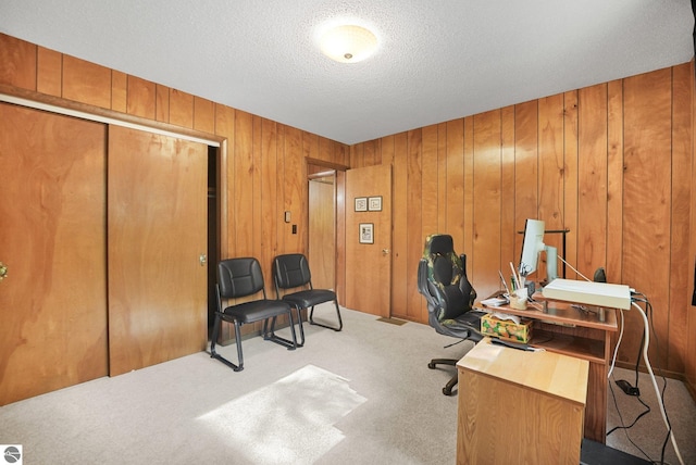 10085 Harmony Dr, Interlochen, MI 49643 - carpeted office space with wood walls and a textured ceiling