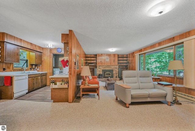 10085 Harmony Dr, Interlochen, MI 49643 - living room with wood walls, a textured ceiling, plenty of natural light, a brick fireplace, and built in features