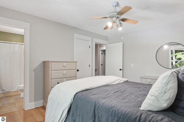 8315 Aimee Ln, Lake Ann, MI 49650 - bedroom featuring light wood-style flooring, a ceiling fan, and connected bathroom