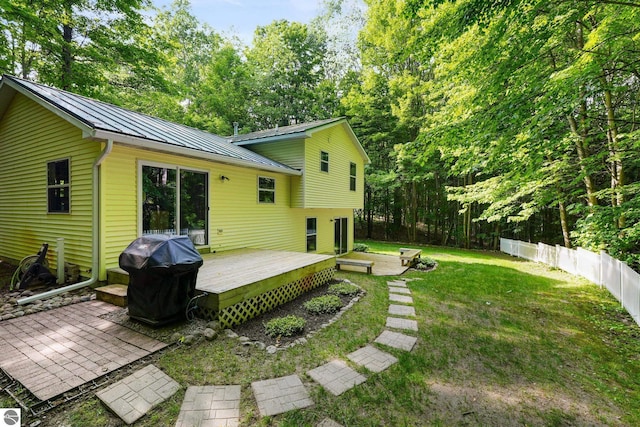 8315 Aimee Ln, Lake Ann, MI 49650 - back of property featuring a standing seam roof, a deck, a metal roof, and a patio