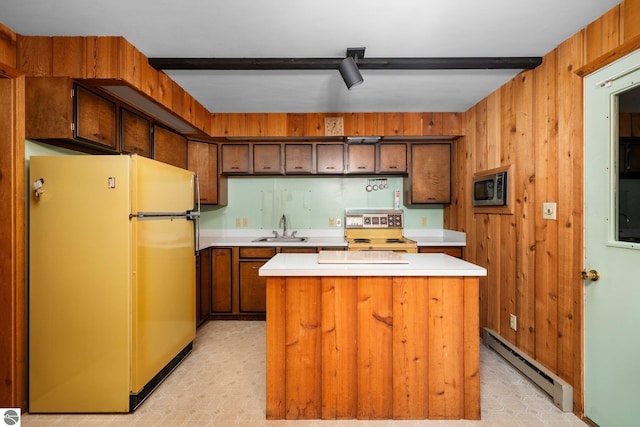 15910 E Cherry Park Dr, Northport, MI 49670 - kitchen with freestanding refrigerator, a baseboard radiator, light countertops, stainless steel microwave, and a center island