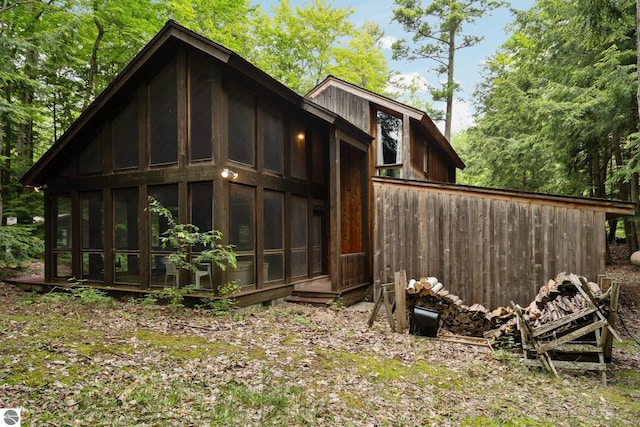 15910 E Cherry Park Dr, Northport, MI 49670 - view of property exterior featuring a sunroom