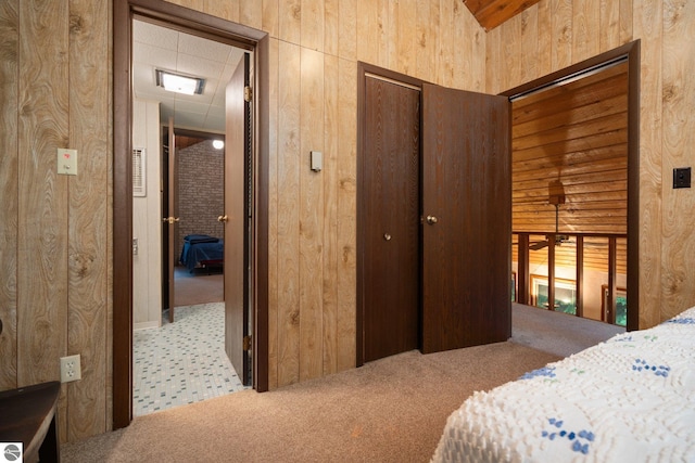 15910 E Cherry Park Dr, Northport, MI 49670 - bedroom with carpet floors, a closet, and wood walls