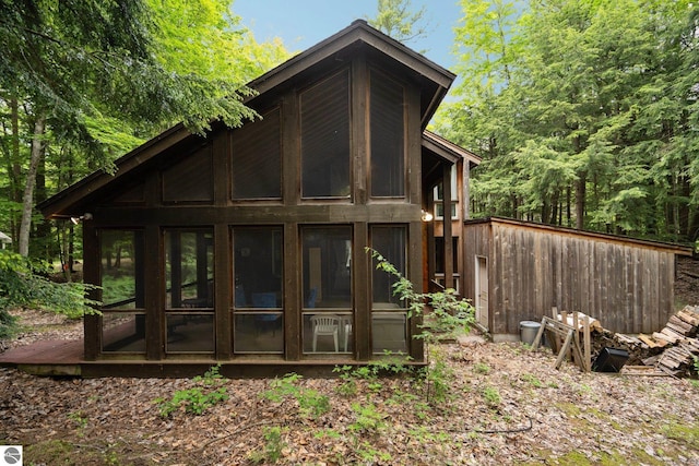 15910 E Cherry Park Dr, Northport, MI 49670 - rear view of property featuring a sunroom