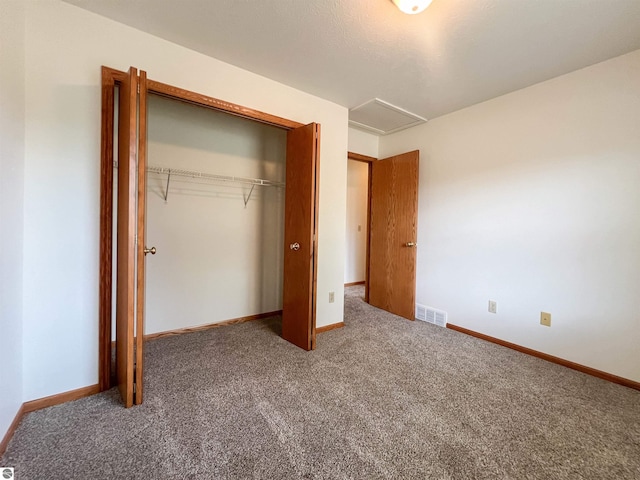3730 Driftwood Dr, Cadillac, MI 49601 - unfurnished bedroom featuring carpet flooring, a closet, and attic access