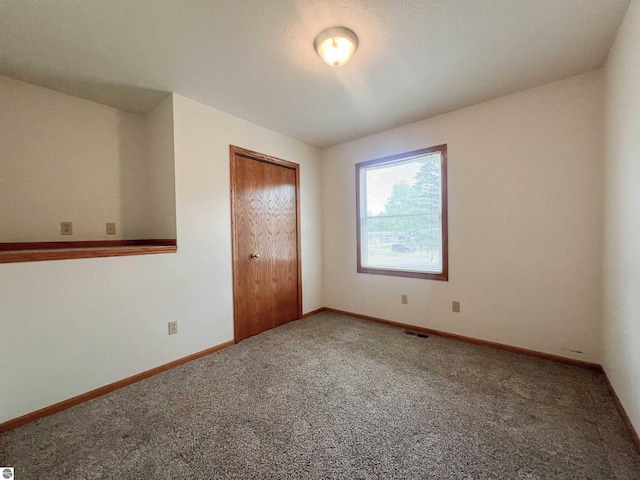 3730 Driftwood Dr, Cadillac, MI 49601 - spare room featuring carpet flooring and baseboards