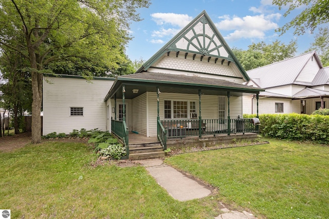 309 W Orchard Ave, Shepherd, MI 48883 - view of front of property featuring covered porch and a front lawn
