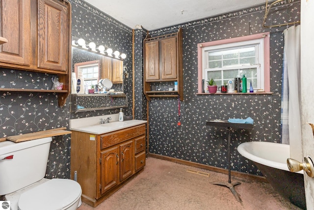 309 W Orchard Ave, Shepherd, MI 48883 - full bathroom featuring wallpapered walls, plenty of natural light, vanity, and a soaking tub