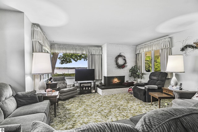 611 Sunset Ln, Cadillac, MI 49601 - living room featuring a large fireplace and carpet floors