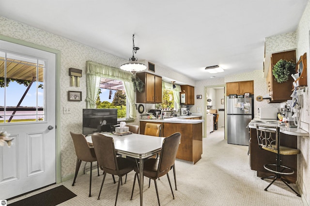611 Sunset Ln, Cadillac, MI 49601 - dining area featuring wallpapered walls and light carpet