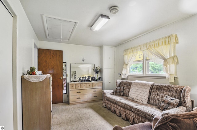 611 Sunset Ln, Cadillac, MI 49601 - living area featuring attic access and light carpet