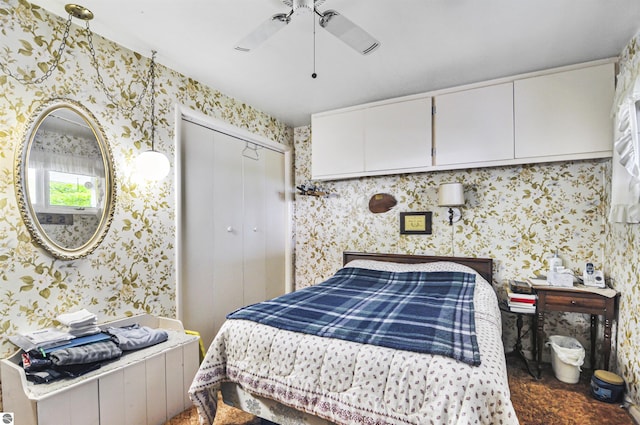611 Sunset Ln, Cadillac, MI 49601 - bedroom with wallpapered walls, a closet, and a ceiling fan