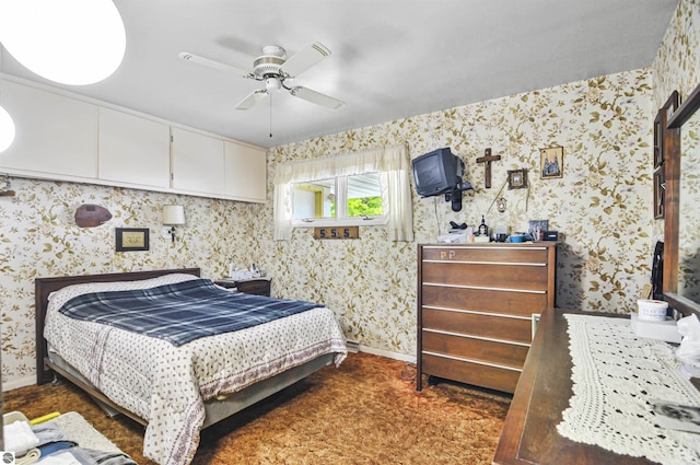 611 Sunset Ln, Cadillac, MI 49601 - bedroom with wallpapered walls and ceiling fan