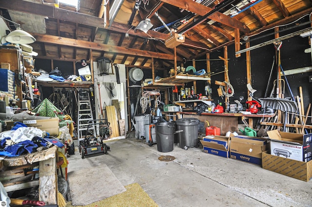 611 Sunset Ln, Cadillac, MI 49601 - garage with a workshop area and a garage door opener