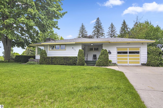 611 Sunset Ln, Cadillac, MI 49601 - view of front of home featuring a garage, driveway, a front lawn, and a chimney