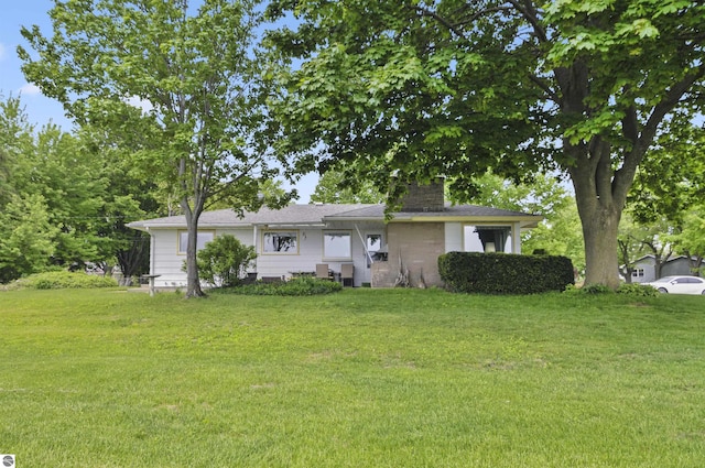 611 Sunset Ln, Cadillac, MI 49601 - view of front facade with a front yard and a chimney