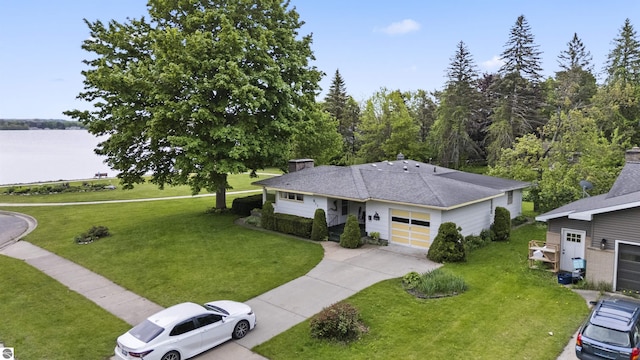 611 Sunset Ln, Cadillac, MI 49601 - view of front of property with driveway, a garage, a front lawn, and a shingled roof