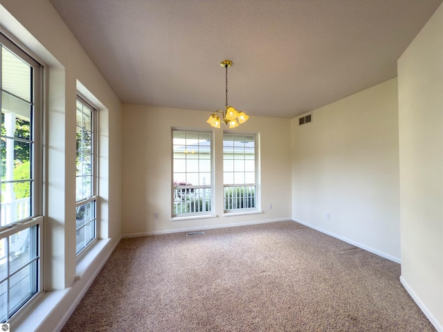 318 Red Maple Ln, Shepherd, MI 48883 - carpeted spare room featuring a chandelier and plenty of natural light